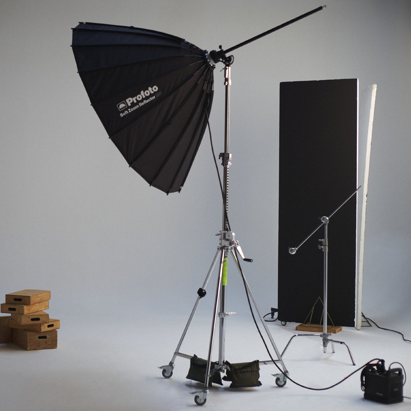 Profoto SoftZoom on a Manfrotto Windup stand and polyboards in the background.