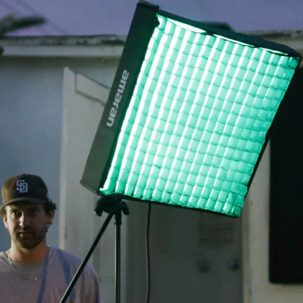 Amaran F22x faric panel on a set, with a tech rigging the light