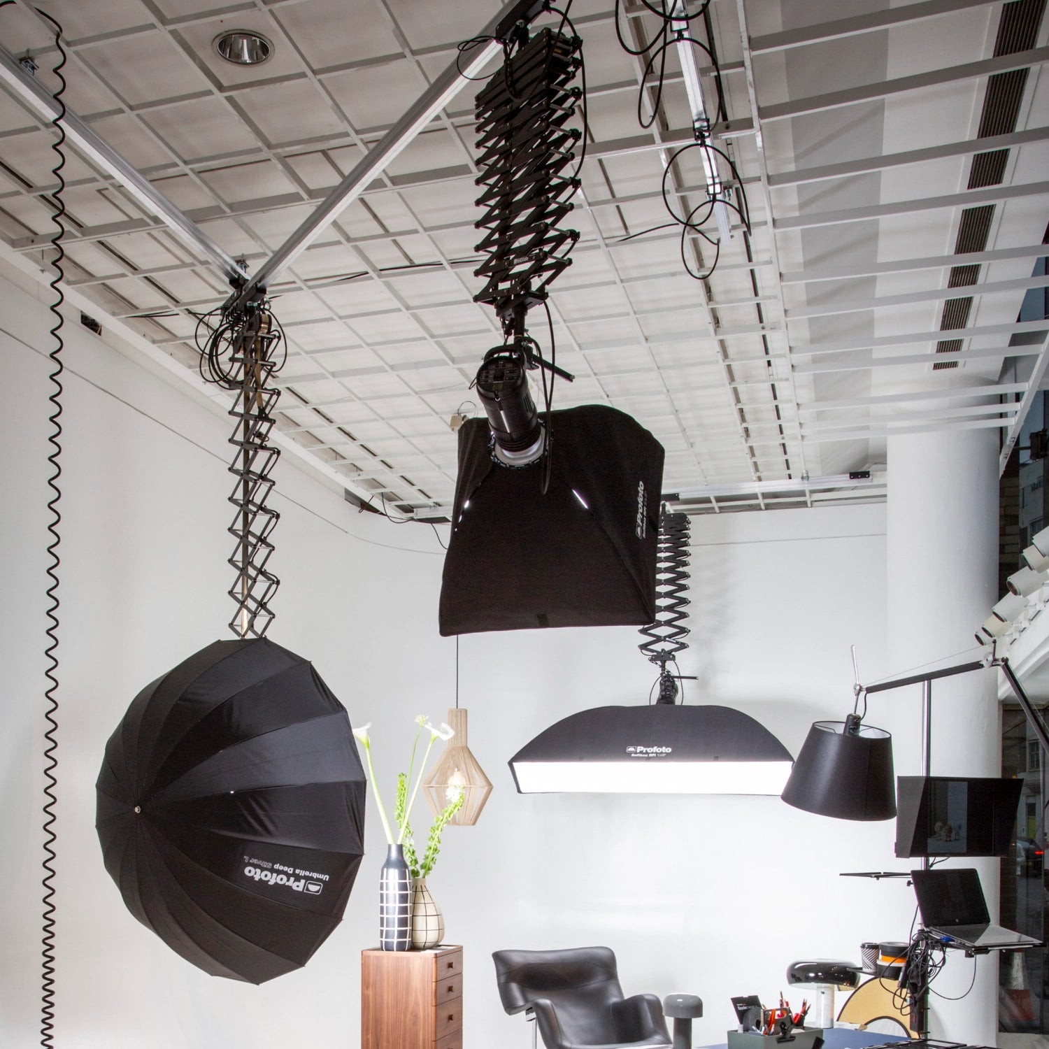 HiGlide ceiling track system in situ in a studio environment,  with Profoto lights, and a scene being ready for photography to begin.