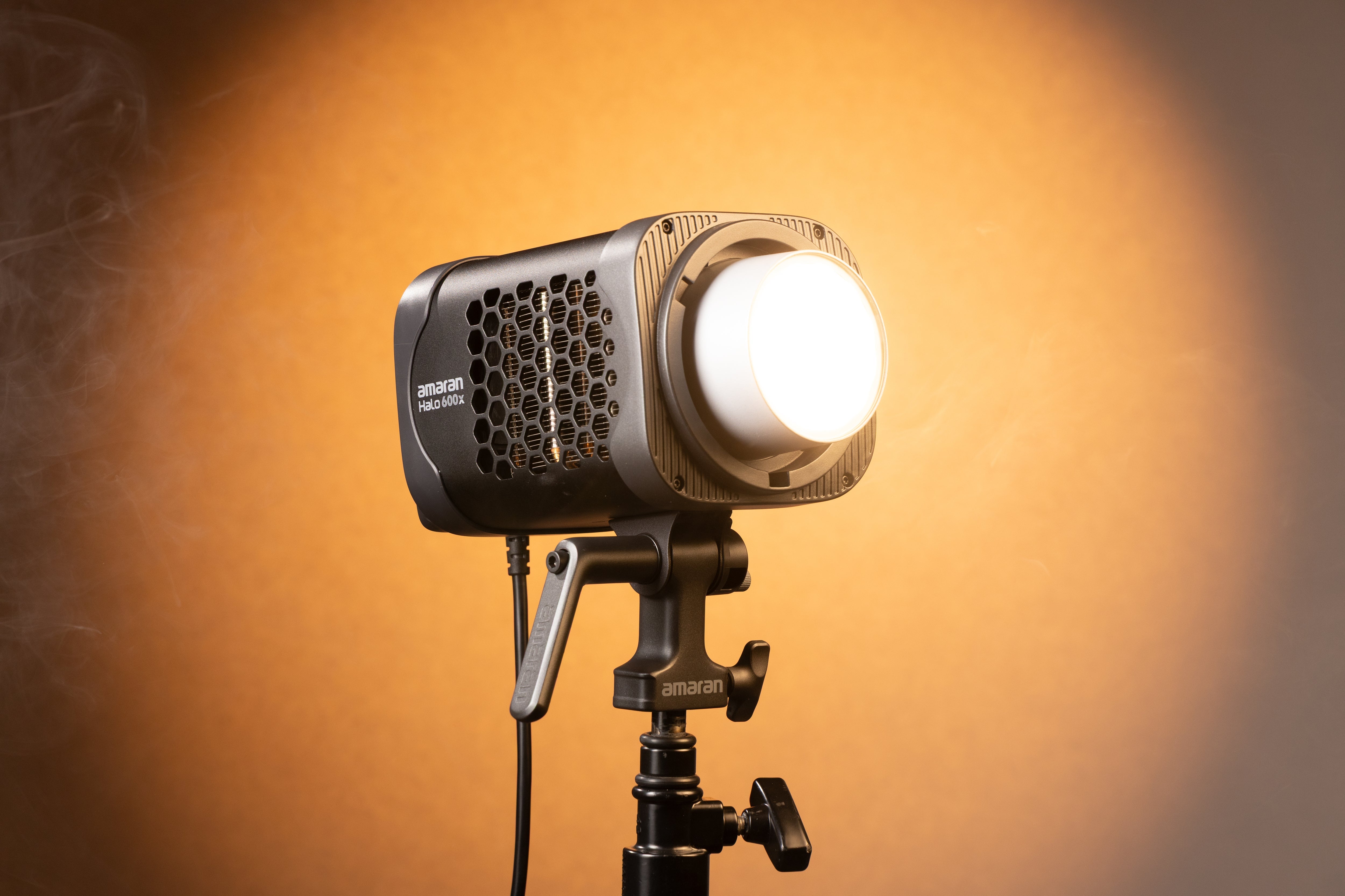 amaran Halo 600x being used with warm lighting as a backdrop.