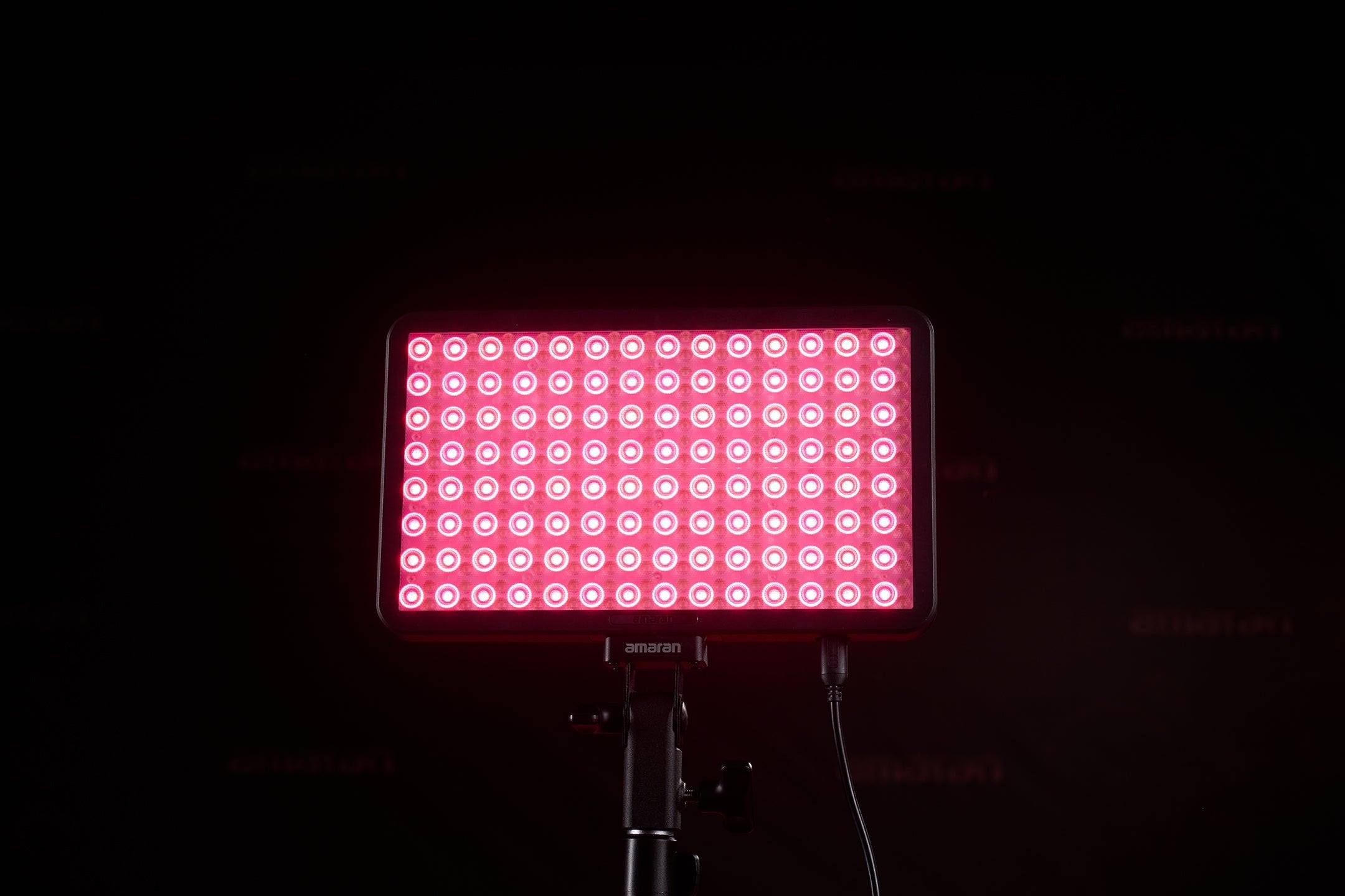 Front view of an amaran Pano 60c illuminating red and white lights.