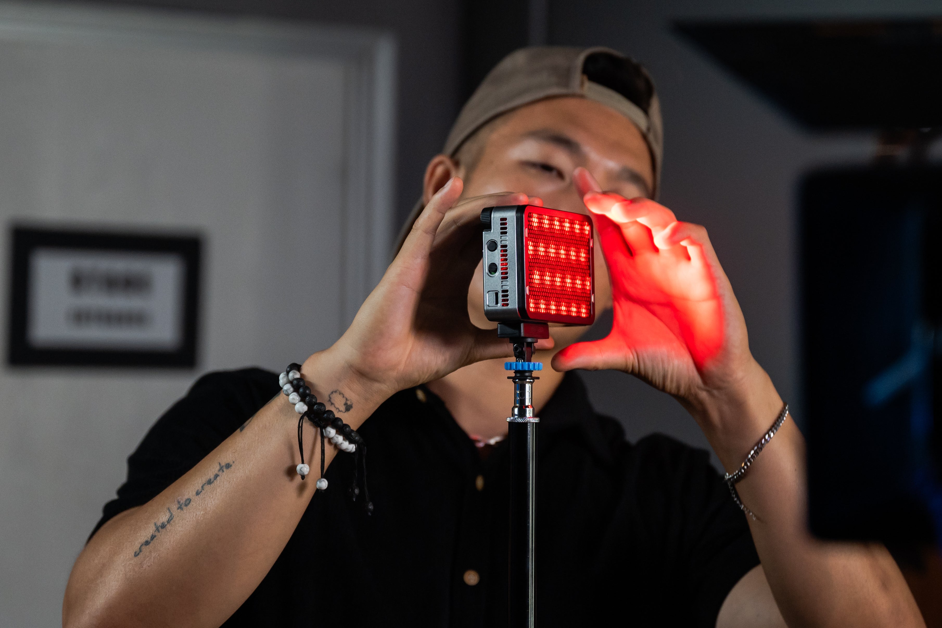 A person attaching the amaran Ace 25c to a stand.