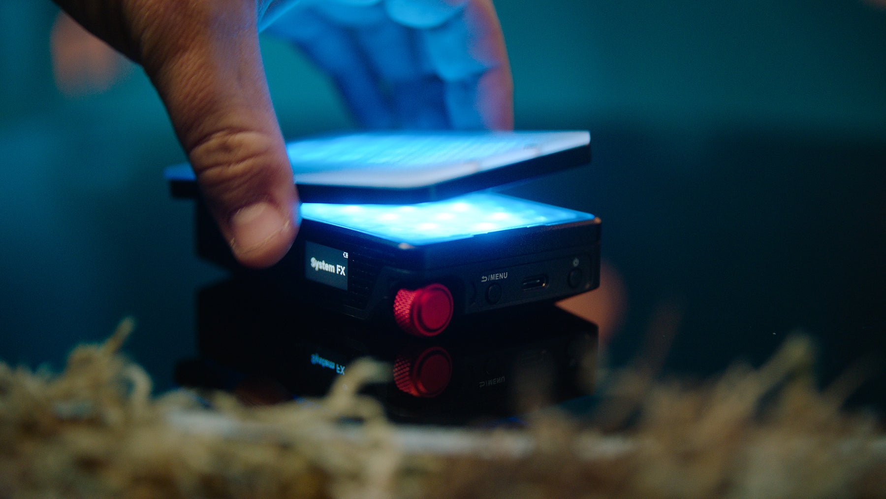 Aputure MC Pro single fixture with the Magnetic Grid being applied with a blue light being emitted