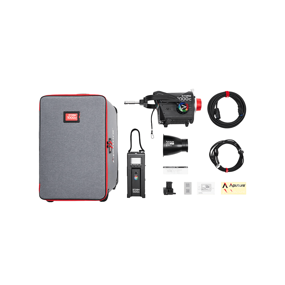 Aputure 1000c Kit, comprising of Ballast, all, UK Cables, Standard Reflecor, cards and V-mount Stand Mount. All on a transparent background.
