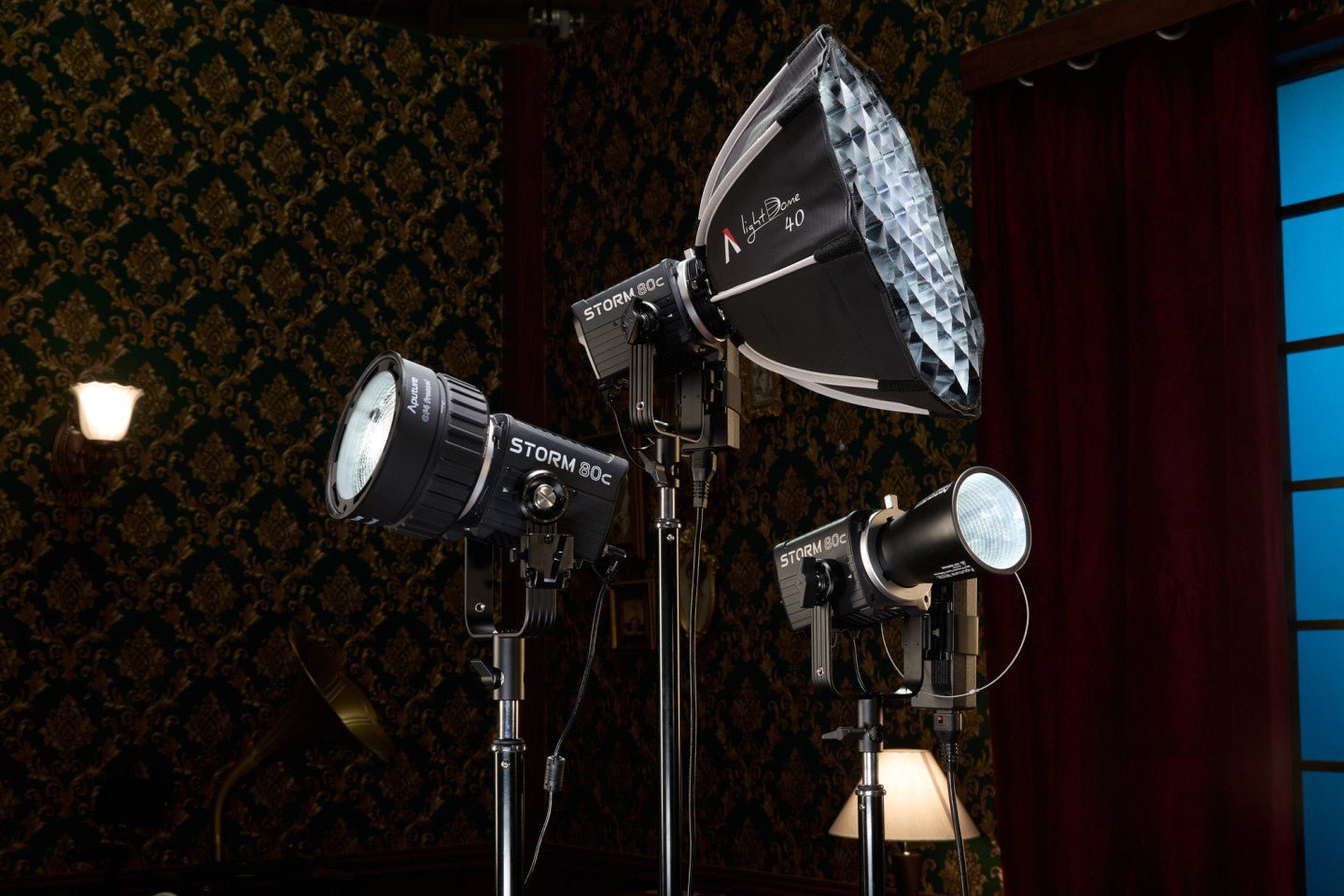 Aputure three head Storm 80c Studio light kit with softboxes on a dark background.