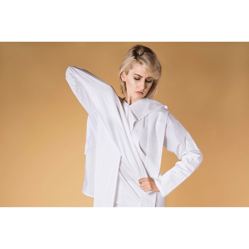 A female model being photographed with the Barley Seamless Studio Background Paper.