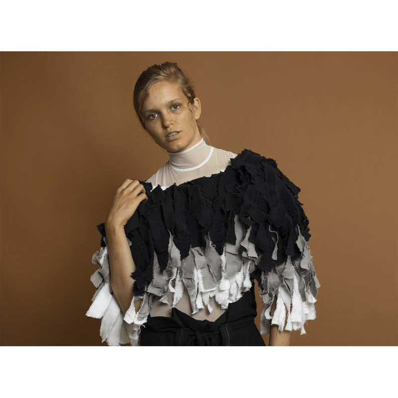 Female model being photographed with the Cardamon background paper.