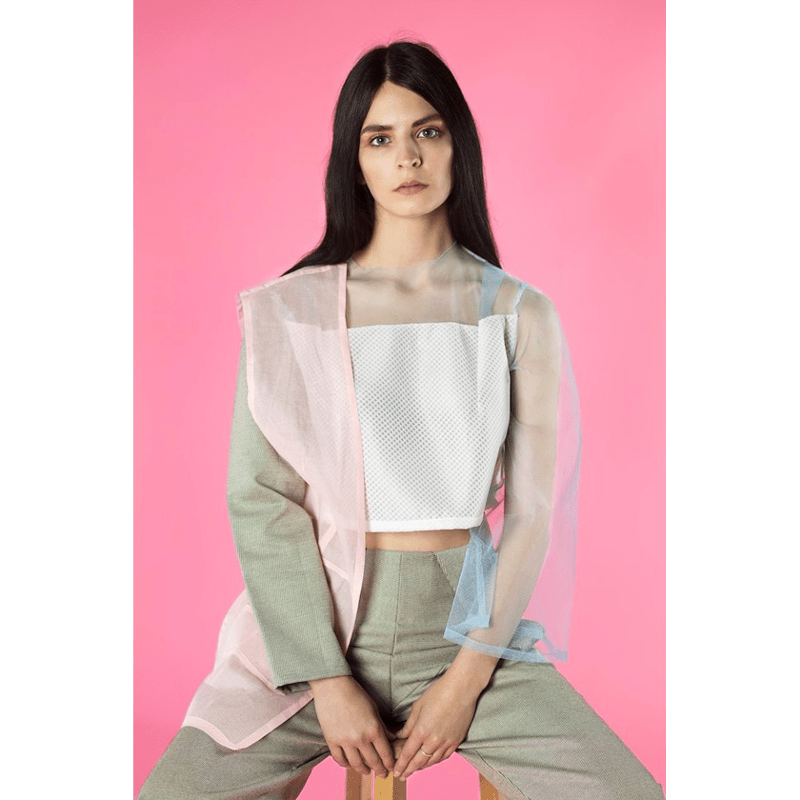Portrait of a Female model being photographed on a Carnation Seamless Background.