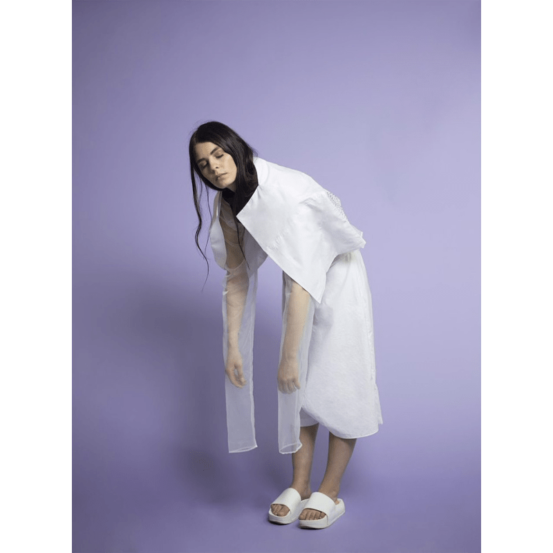 Female Model being photographed with a Lilac Seamless Colorama Background.