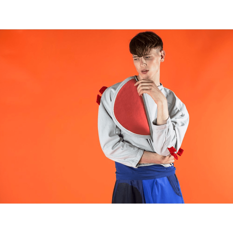 Colorama Pumpkin Seamless Background Paper being utilised on shoot with a Male Model.