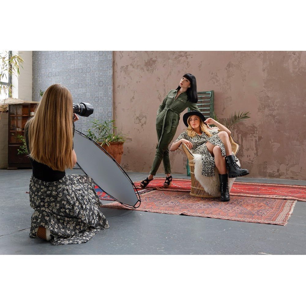 HaloCompact Plus Reflector 98cm (38'') Silver/White being utilised on a photoshoot with two female models.