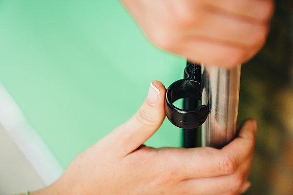 A person attaching the green fabric to the frame for the Manfrotto Ezy Frame 2x2.3m Chromakey Green Background.