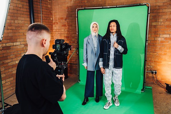 Two models being pictured with the Ezy Frame 2x2.3m Chromakey Green Background.