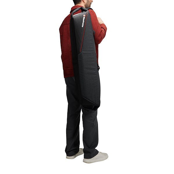 A person carrying a Manfrotto Pro Light Tripod Bag 88 on his back, showing its portability.