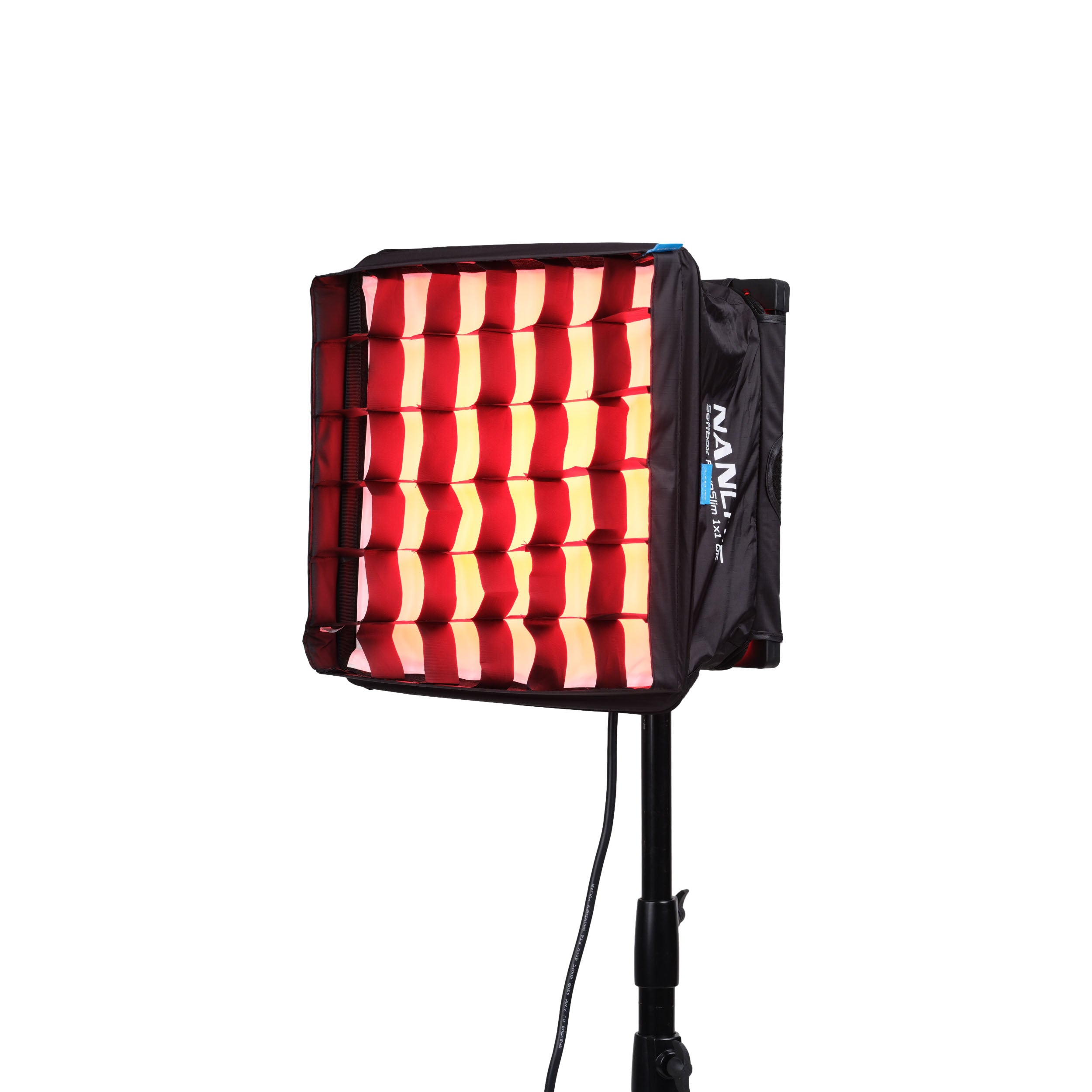 Side view of NANLITE PavoSlim 60C LED RGBWW Panel Light with a grid projecting red light.