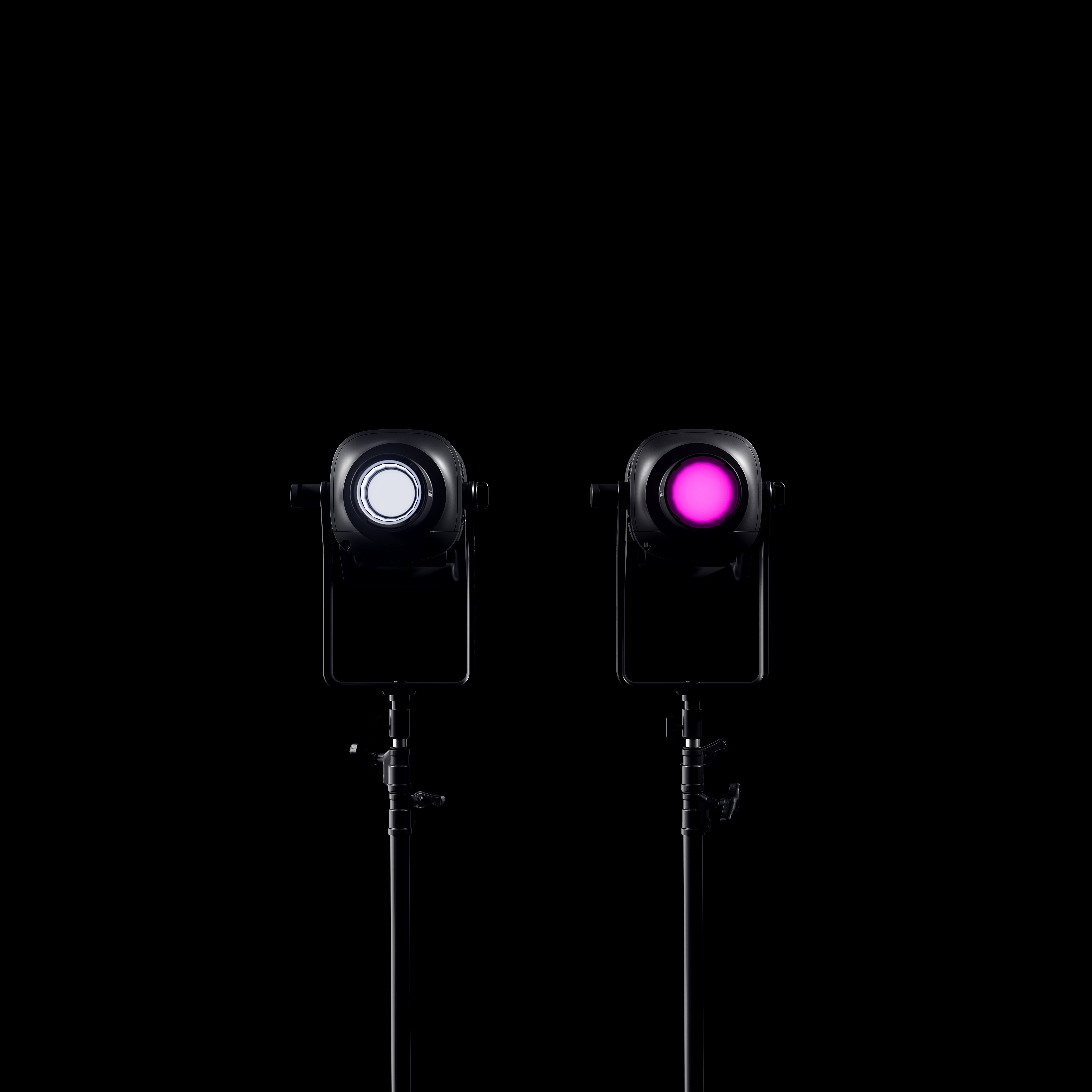 Two Profoto L600C's shown in darkness projecting white and pink light.