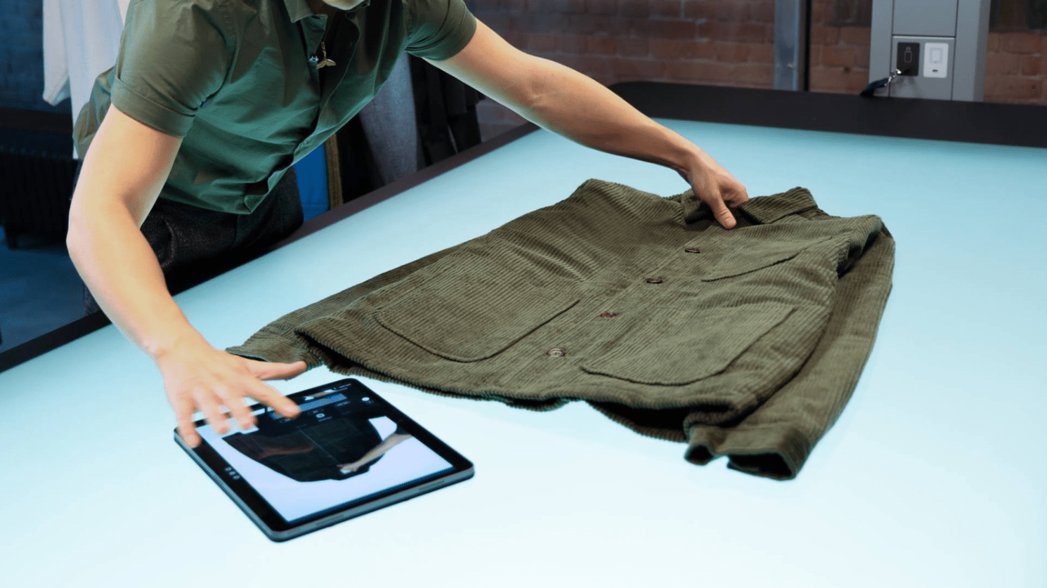 A person adjusting the subject in a photoshoot using the Profoto StyleShoots Horizontal automated device.