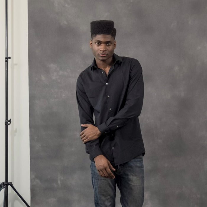 Male model being pictured with a Savage Ash 1.52x2.13m Background.