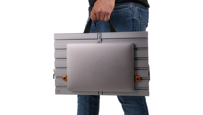 A person utilising the Tether Tools AeroTrac Handle on the workstation.