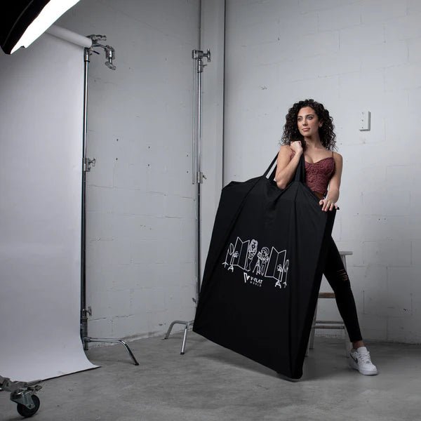 Foldable V-Flat 2.0 Carry bag being utilised by a model in a studio environment.