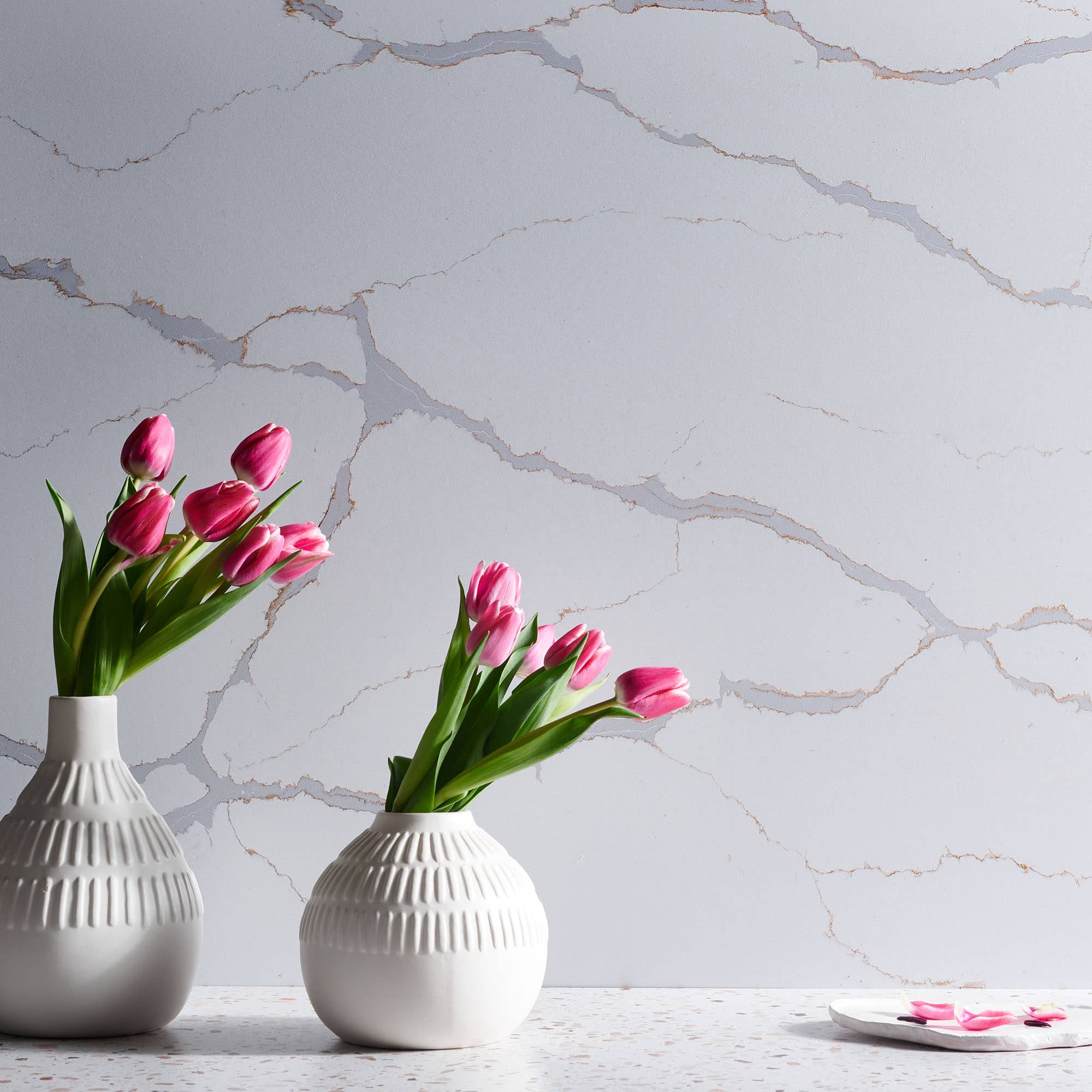 V-Flat Carrara Blue/Calacatta Gold Duo Board as a background with some flowers.