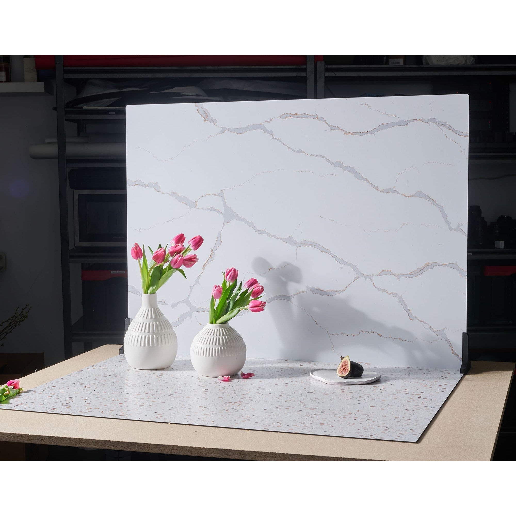 V-Flat Carrara Blue/Calacatta Gold Duo Board on a tabletop with flowers.