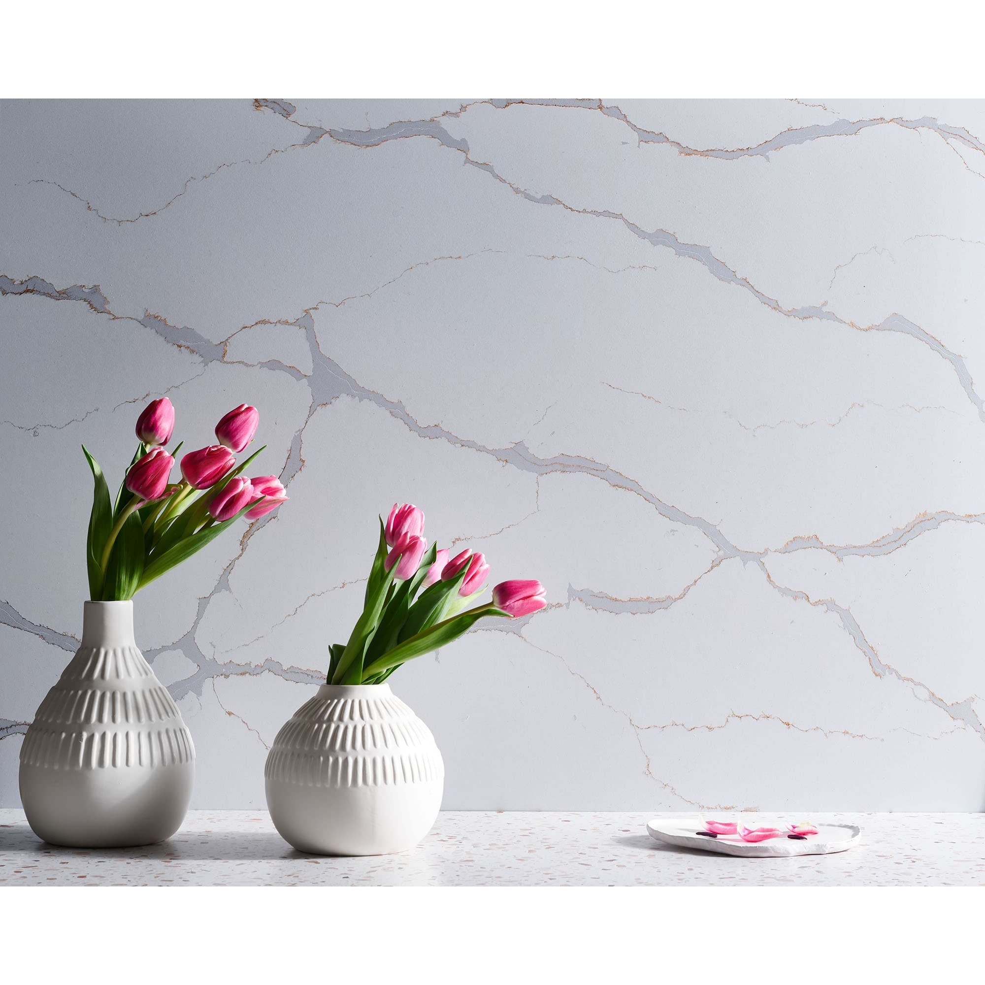 V-Flat Carrara Blue/Calacatta Gold Duo Board with flowers being photographed.