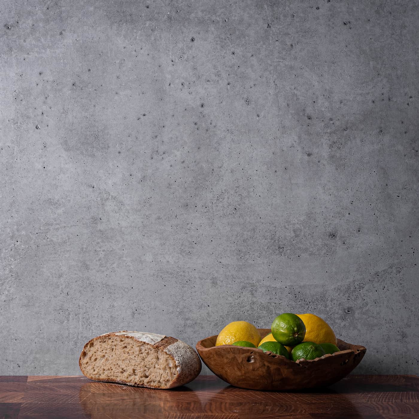 V-Flat Iced Concrete/Midnight Cement Duo Board being used with bread and fruit being photographed.