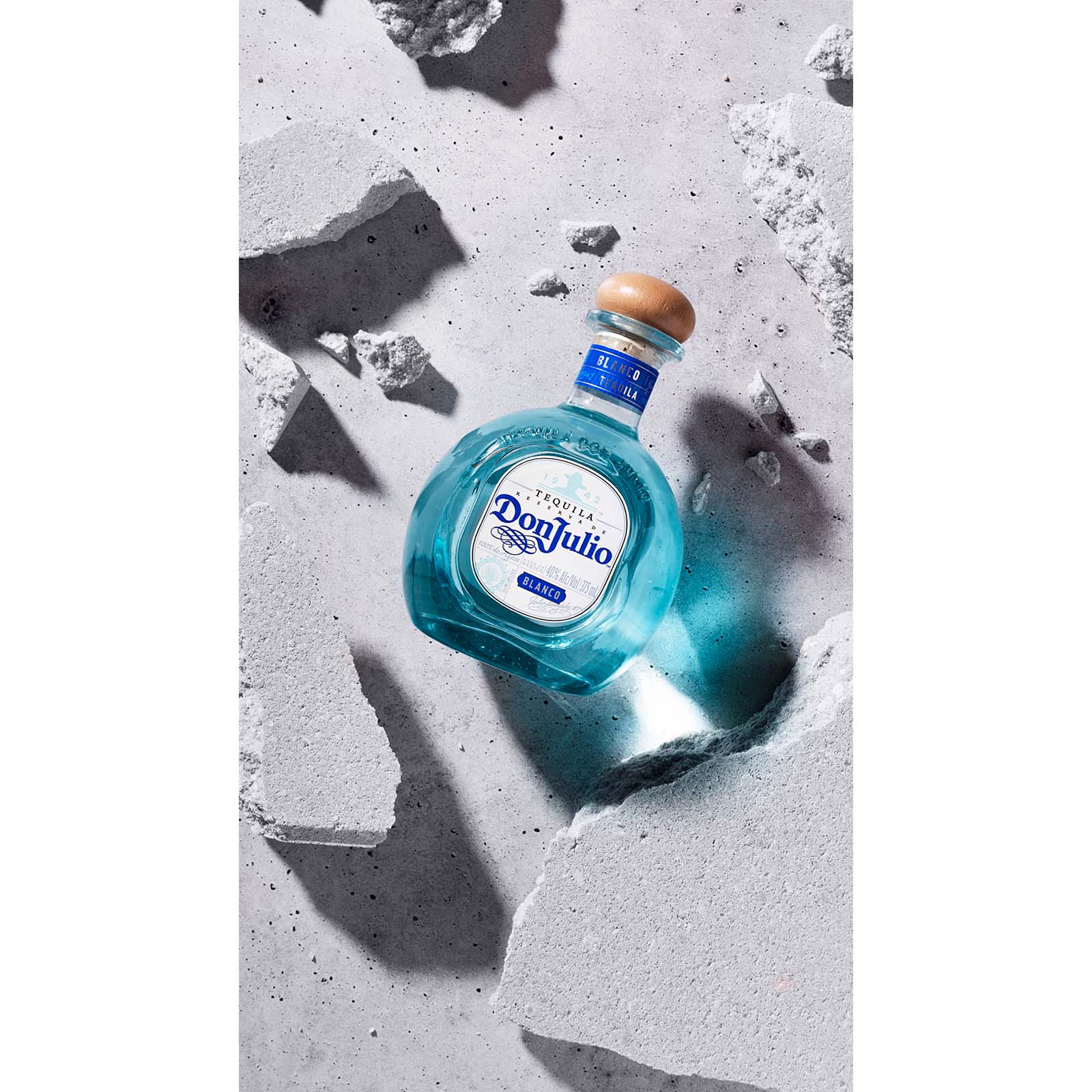 V-Flat Iced Concrete/Midnight Cement Duo Board shown with a bottle of Tequila.