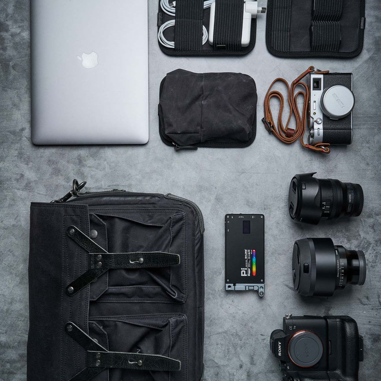 A photographer's equipment photographed from birds eye view using the V-Flat Iced Concrete/Midnight Cement - XL Duo Board.