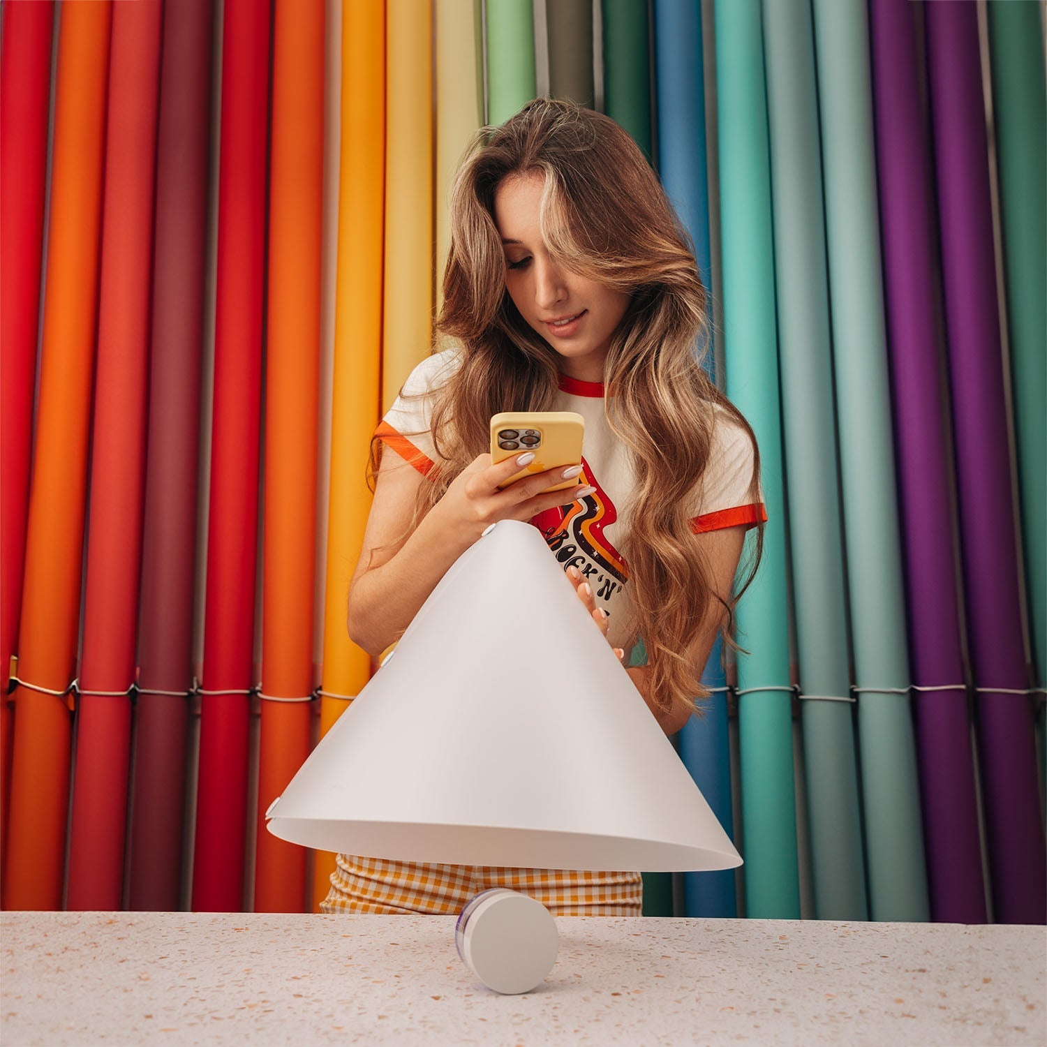 A person photographinga small product using the V-Flat Light Cone - Phone.