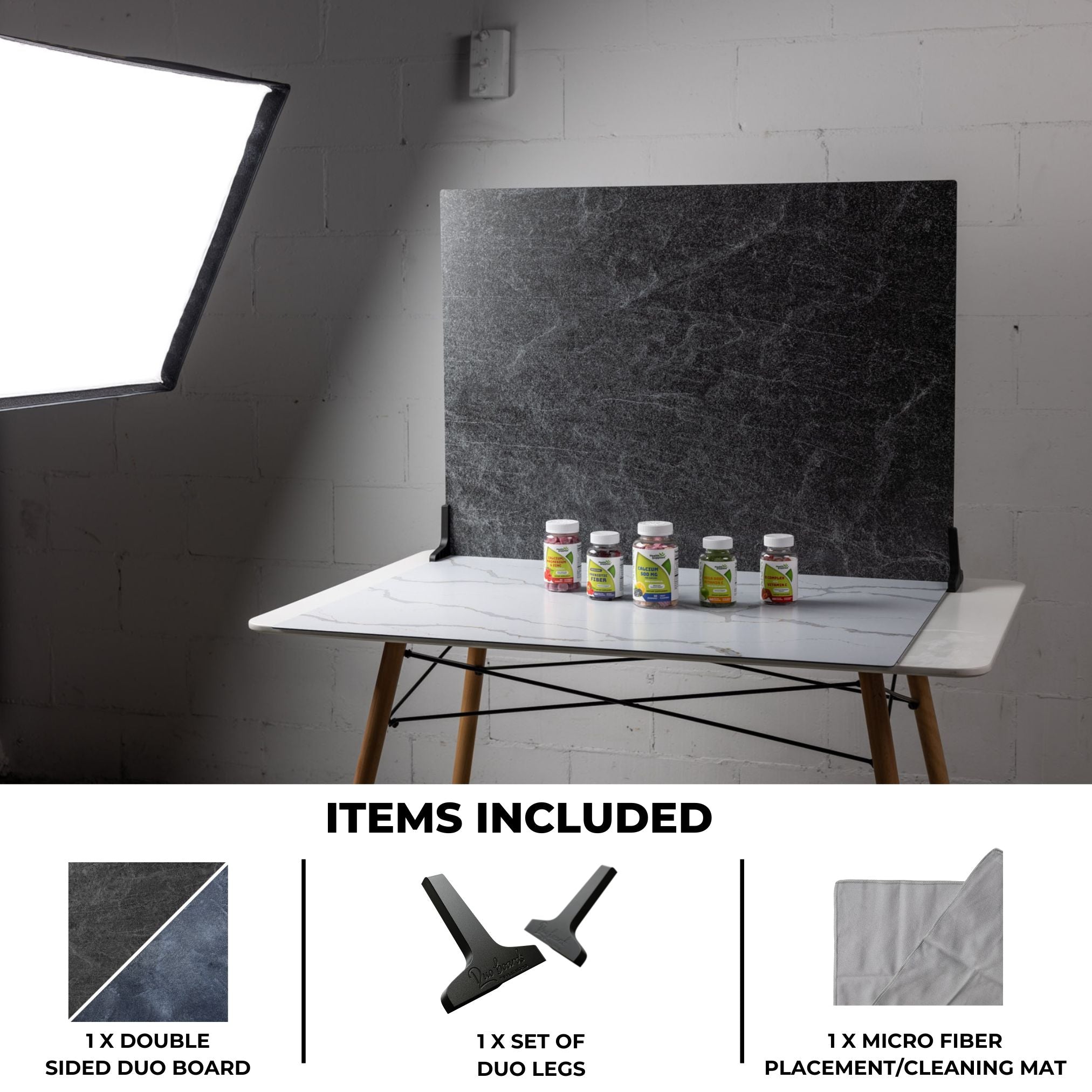 V-Flat Ocean Slate/Black Slate - XL Duo Board on a tabletop with some products being photographed.