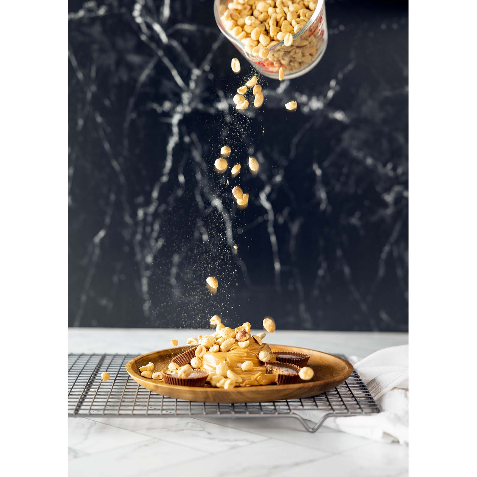 Action image capturing nuts being poured utilising a V-Flat Onyx Marble/Alpine Marble - XL Duo Board.