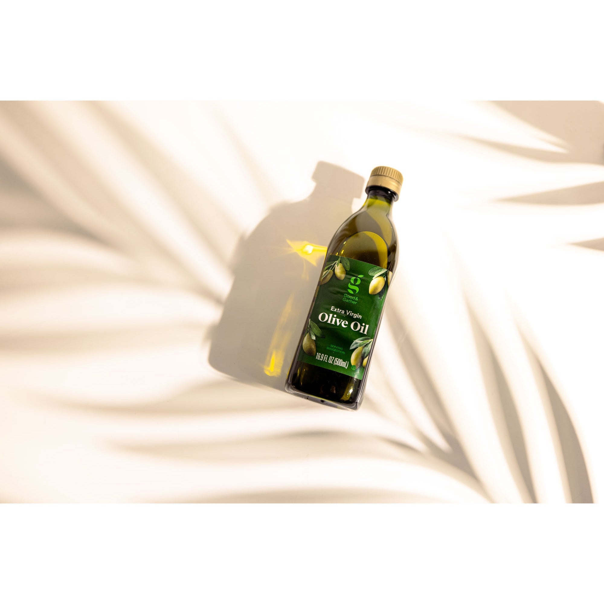 V-Flat Palm Leaf being utilised to photograph Olive Oil on a white background.