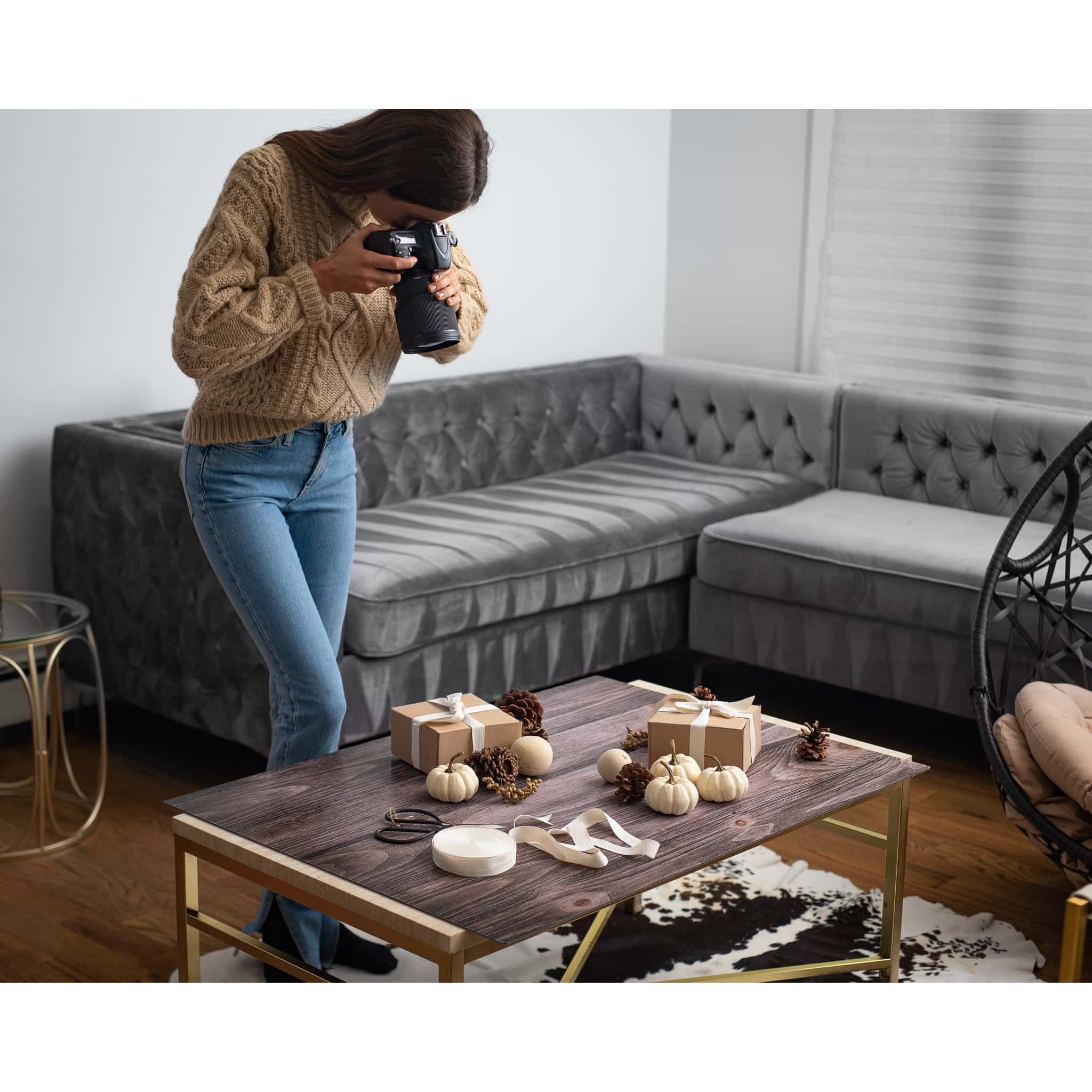 A photographer capturing presents utilising the V-Flat Vintage Oak/Ink Hardwood - XL Duo Board as a background.