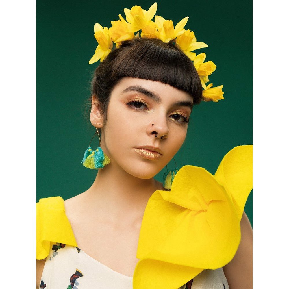 Portrait of a female model pictured with a Colorama Spruce Green Background.