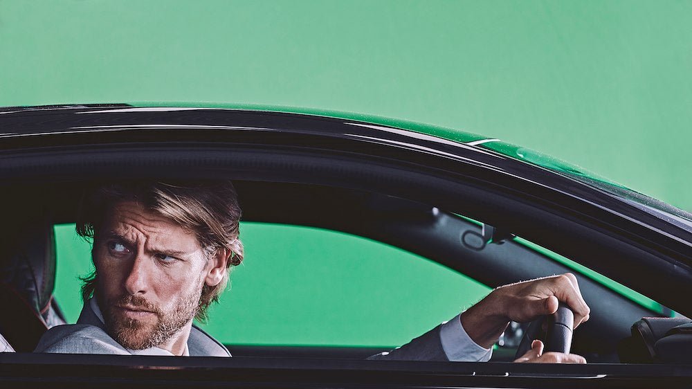 Man in a car with the green Lastolite reversible background.