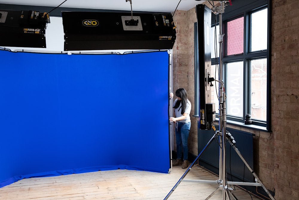 Setting up a 4m Chromakey blue panoramic Lastolite Background.