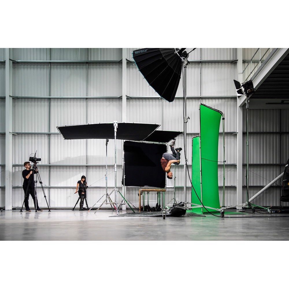 Manfrotto Chromakey Background being utilised on set with various Light Shapers to capture a man's acrobatics.