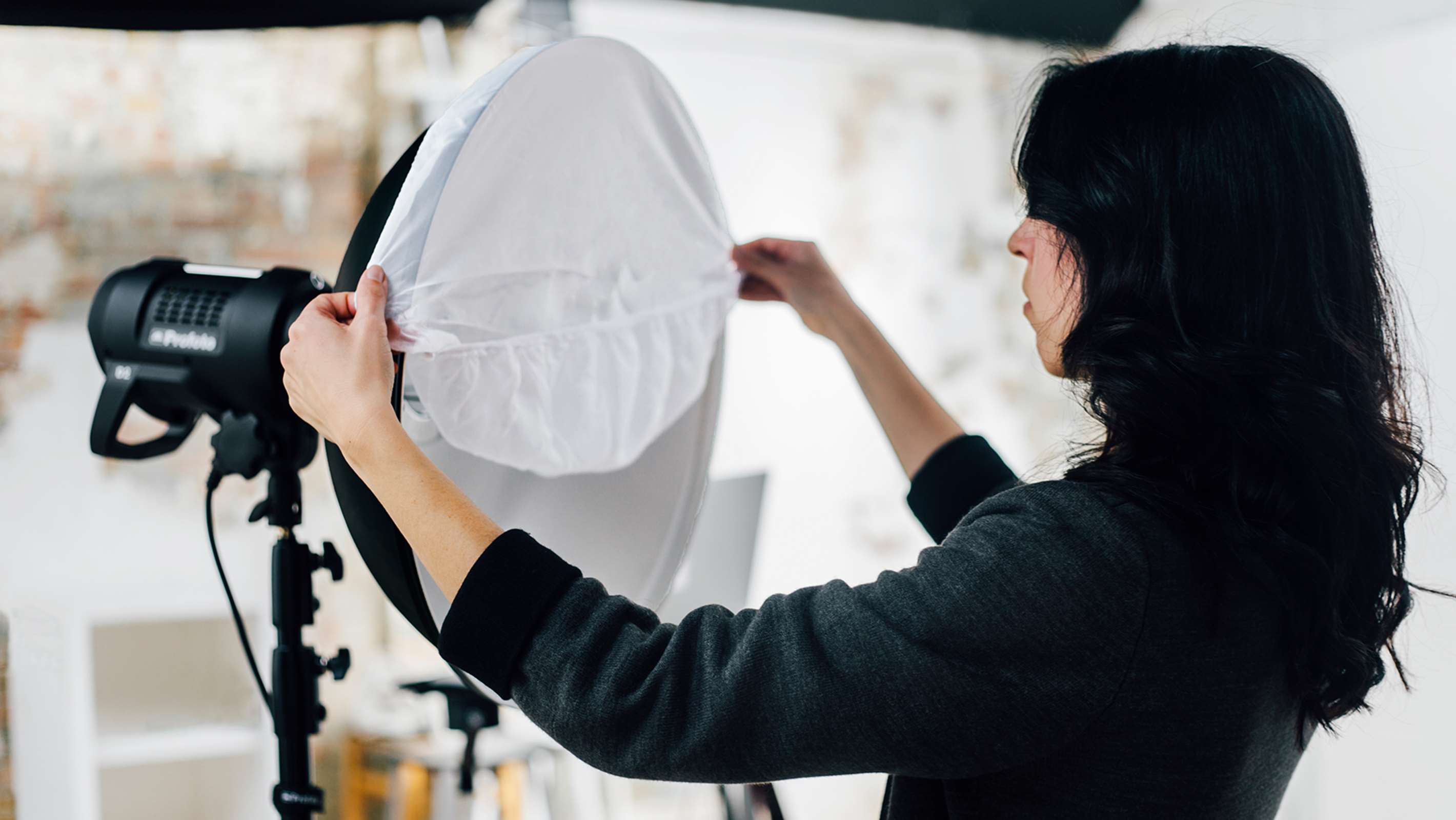 Profoto diffusion sock being added to the Profoto Soflight Reflector Beauty Dish.