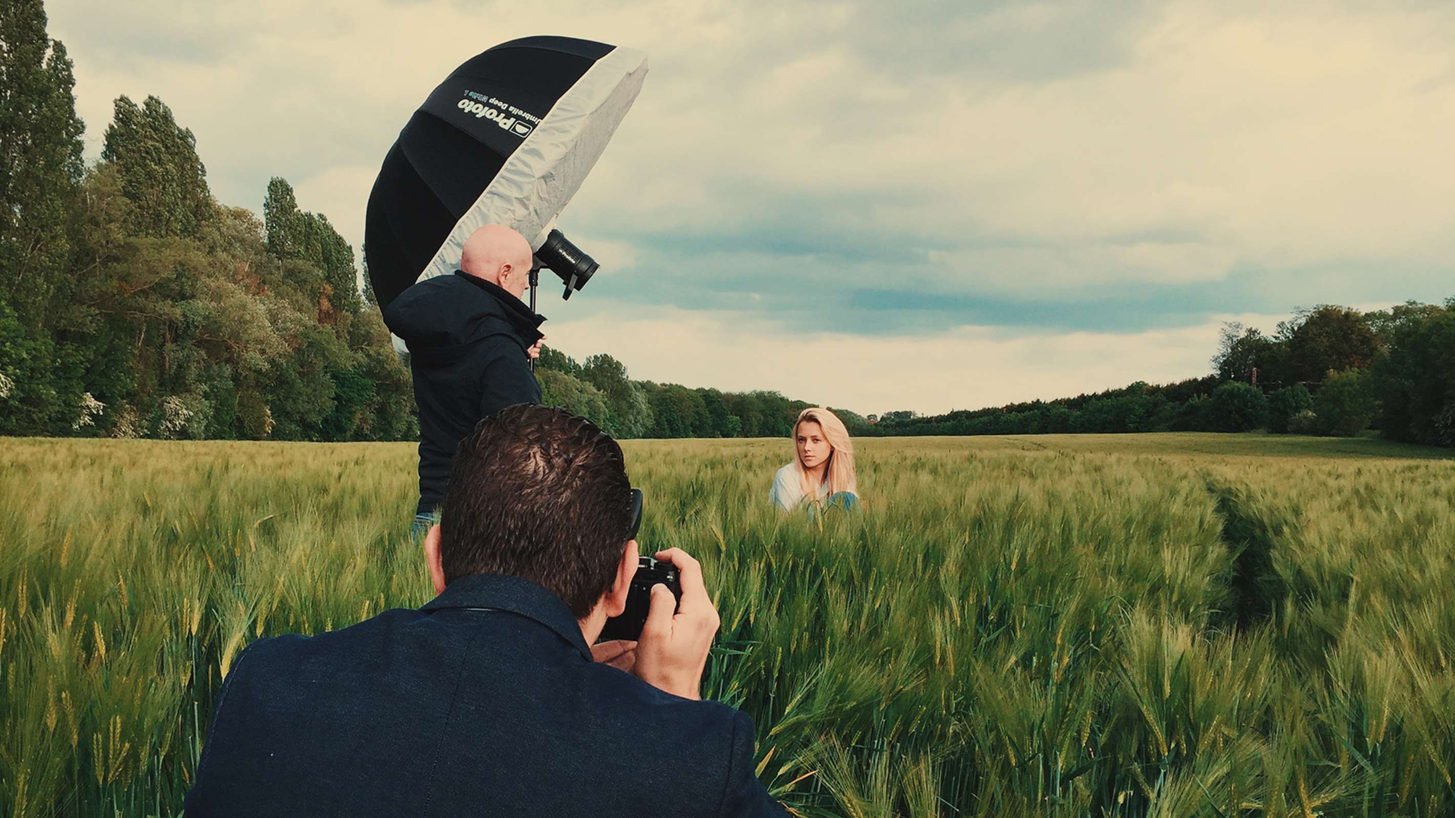 Umbrella with a diffuser being used on a location shoot.