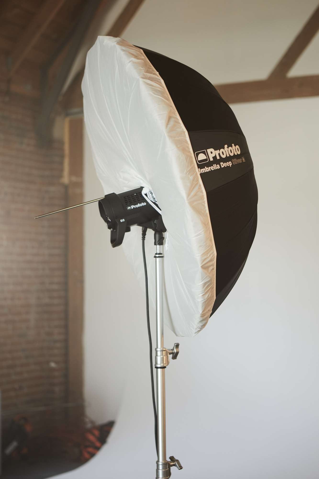 Umbrella with a diffuser being used on a location shoot.