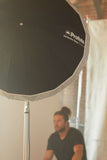 Umbrella with a diffuser being used on a location shoot