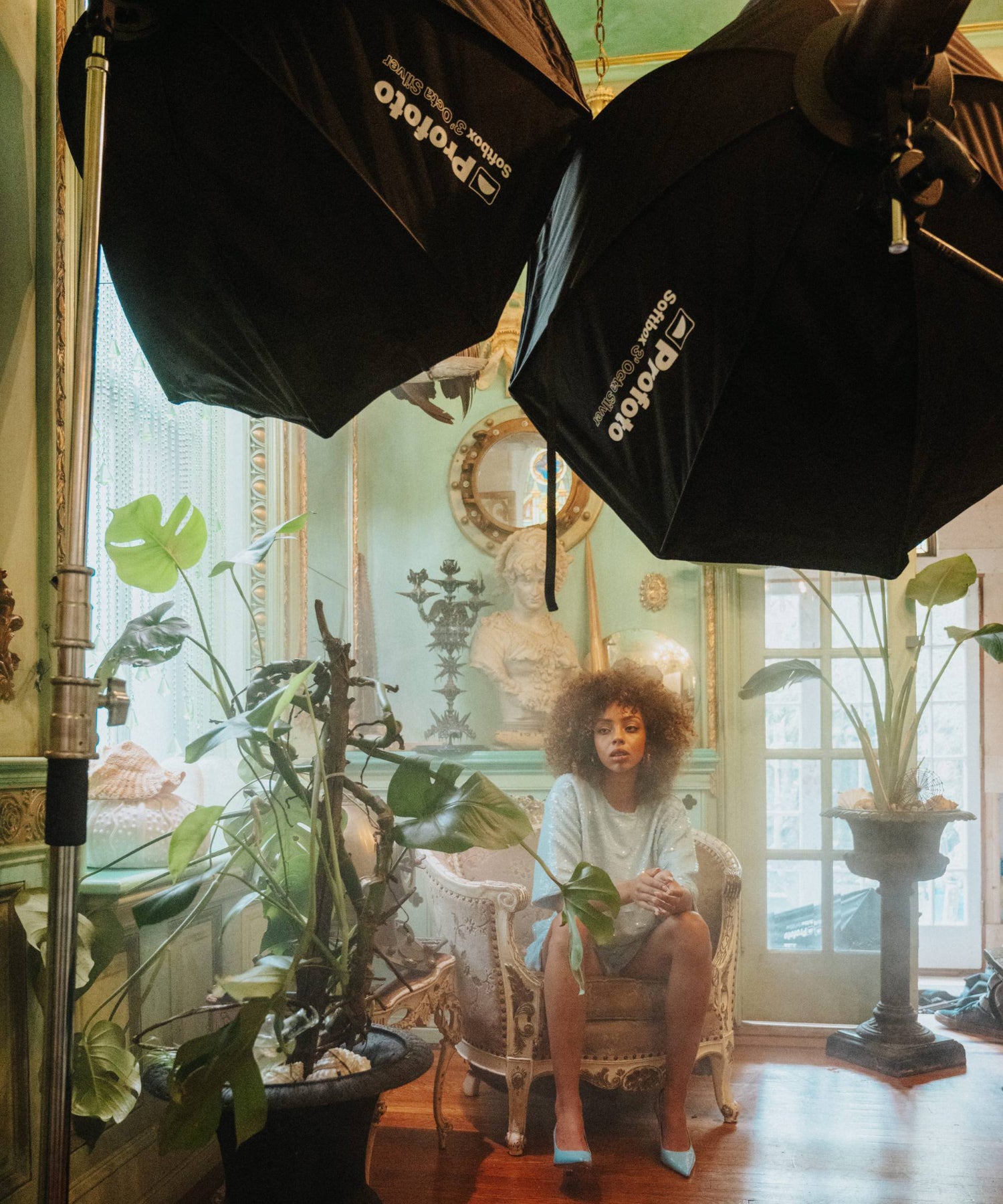 Woman illuminated by two Profoot Sofboxes in a bohemian style envioment. 