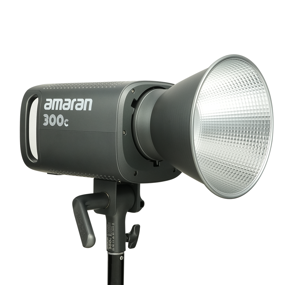 Side view of Amaran 300c LED CoB light with Bowens Mount Hyper reflector attached on a transparent background.