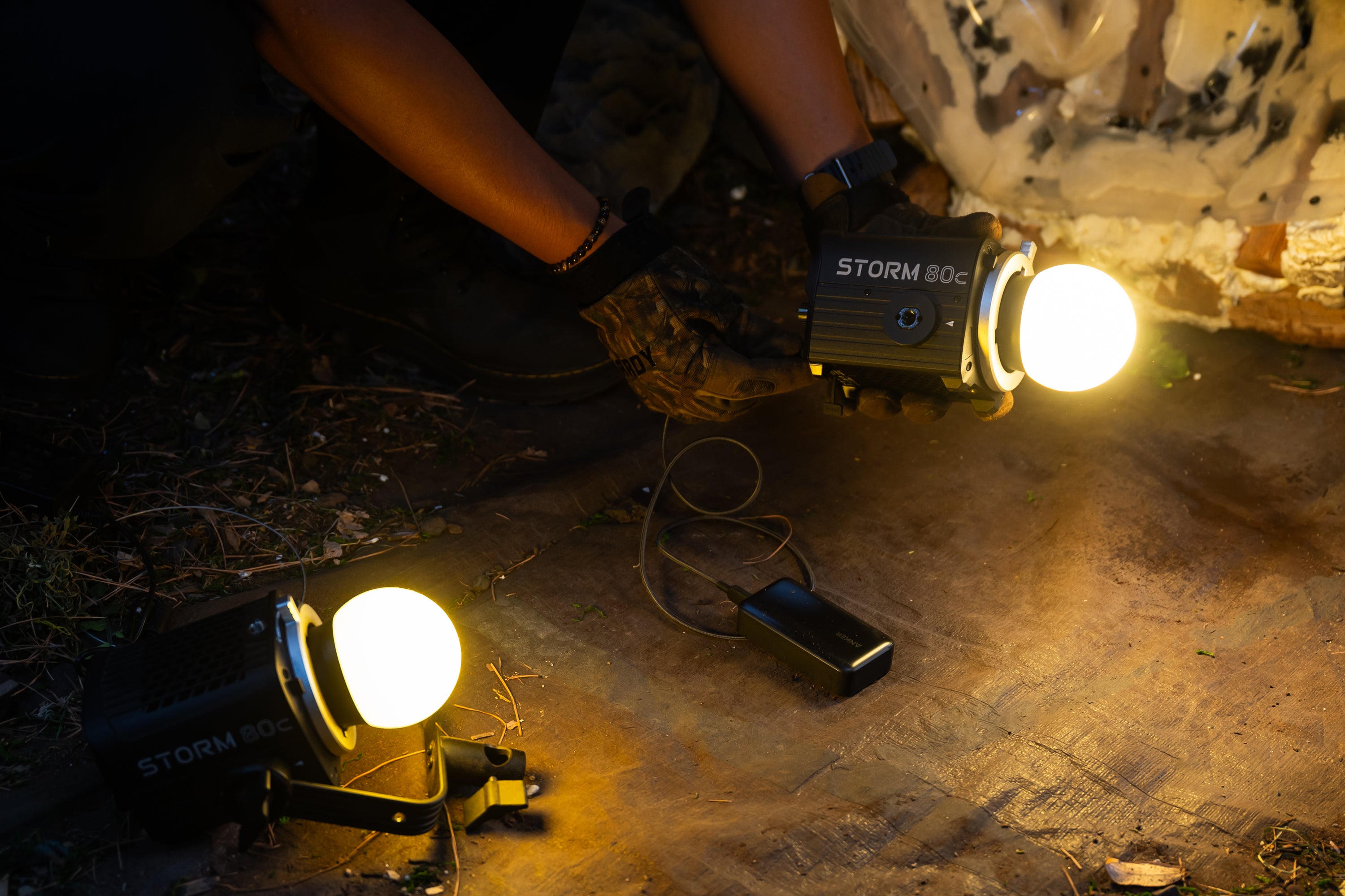 Two Aputure Storm 80c fixtures with Mini Lantern Diffusers (globes) attached, on location. 