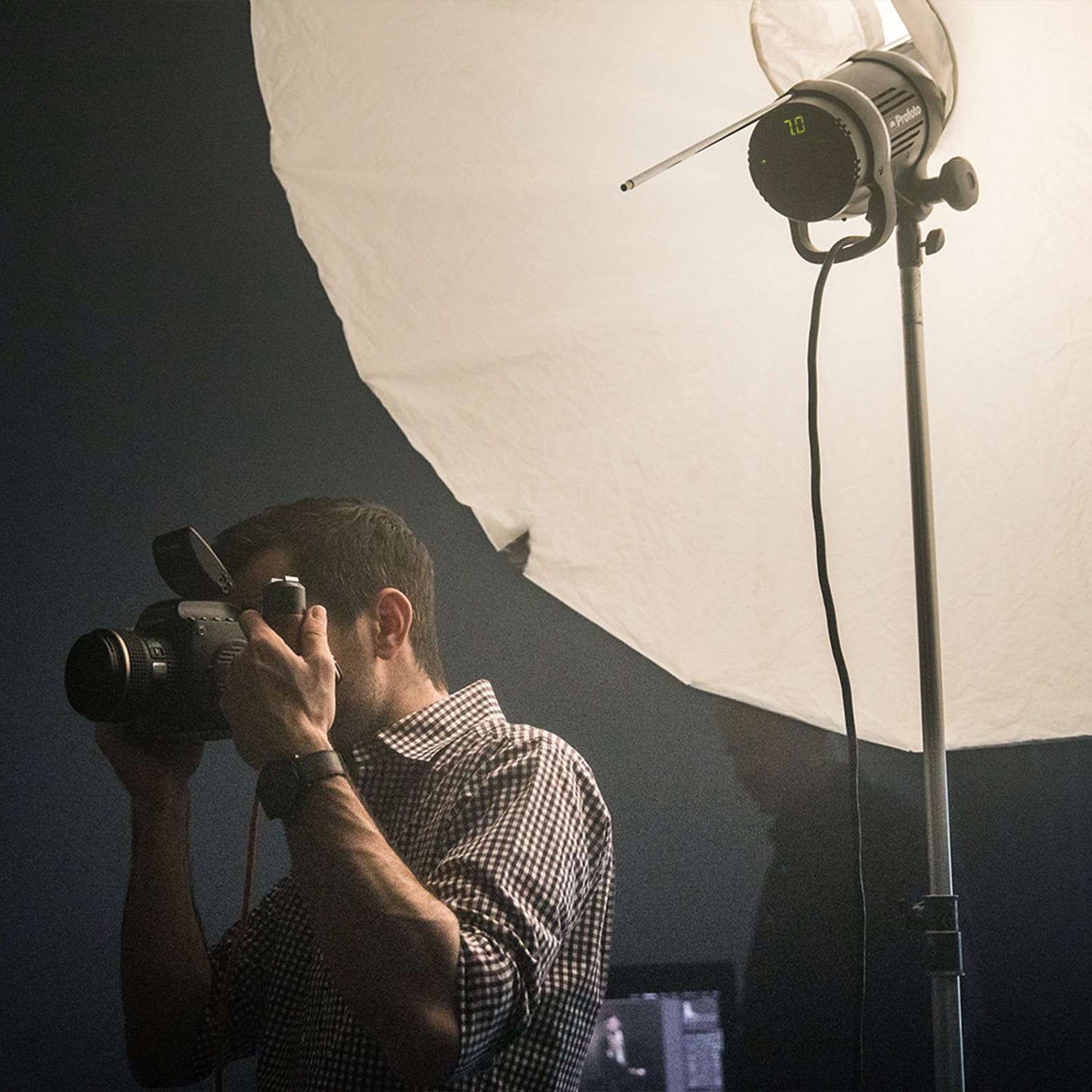 Profoto Studio Flash in a Profoto Umbrella with man in the foreground