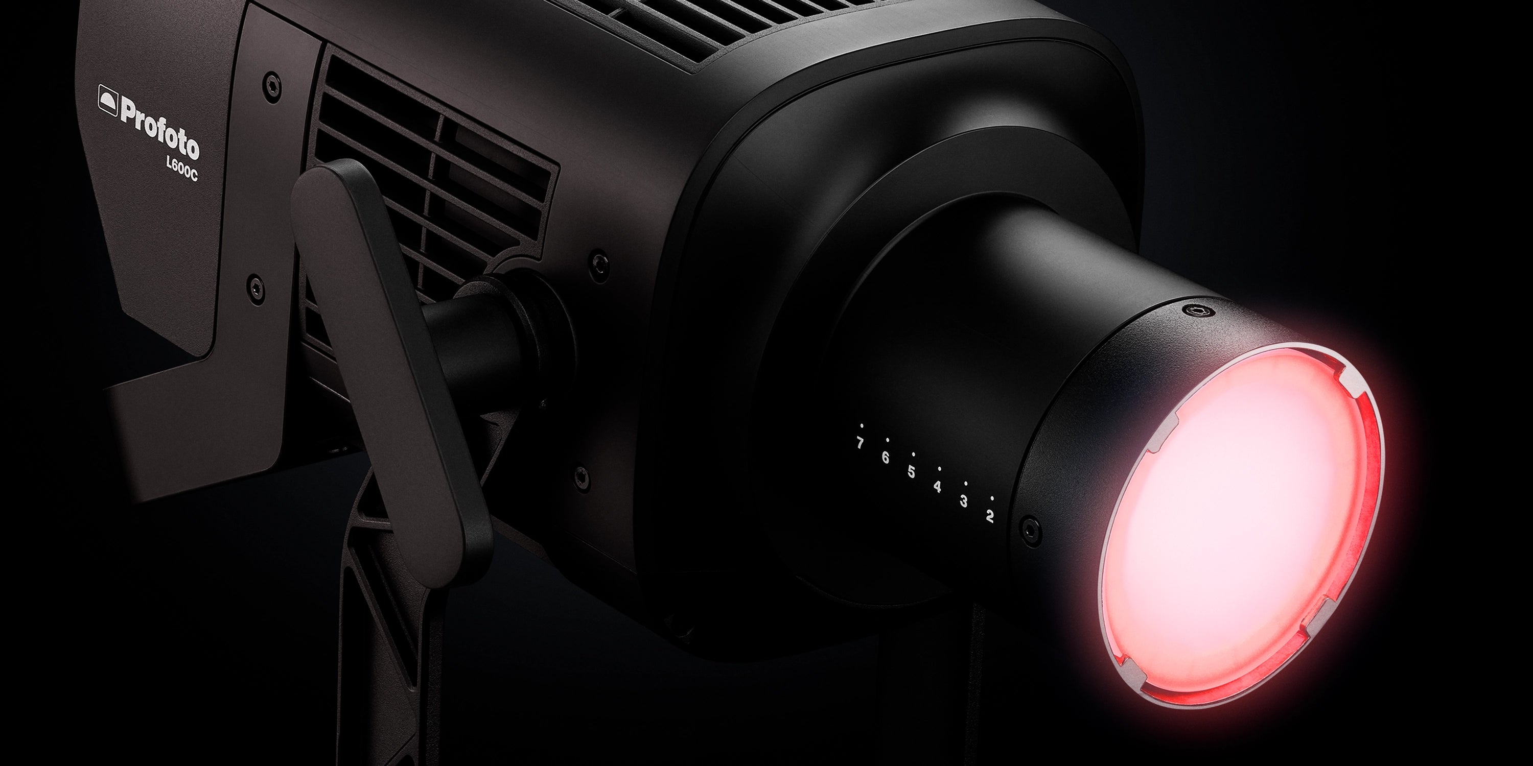 Black light fixture with red glow on a black background, featuring the New Profoto L600C.