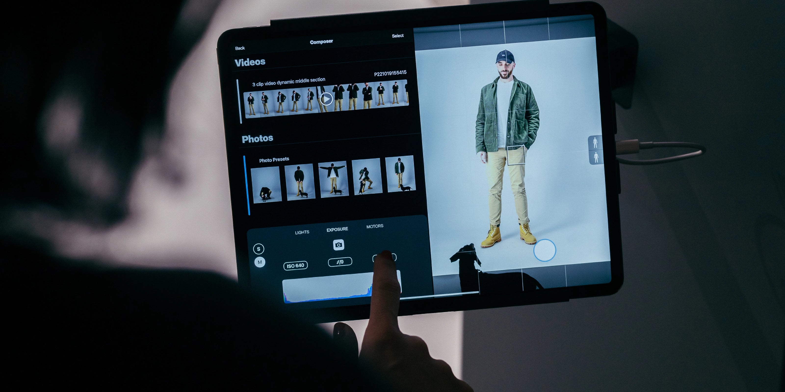 Person using an iPad to control the StyleShoots device to take photos and video of a model for e-commerce imagery.