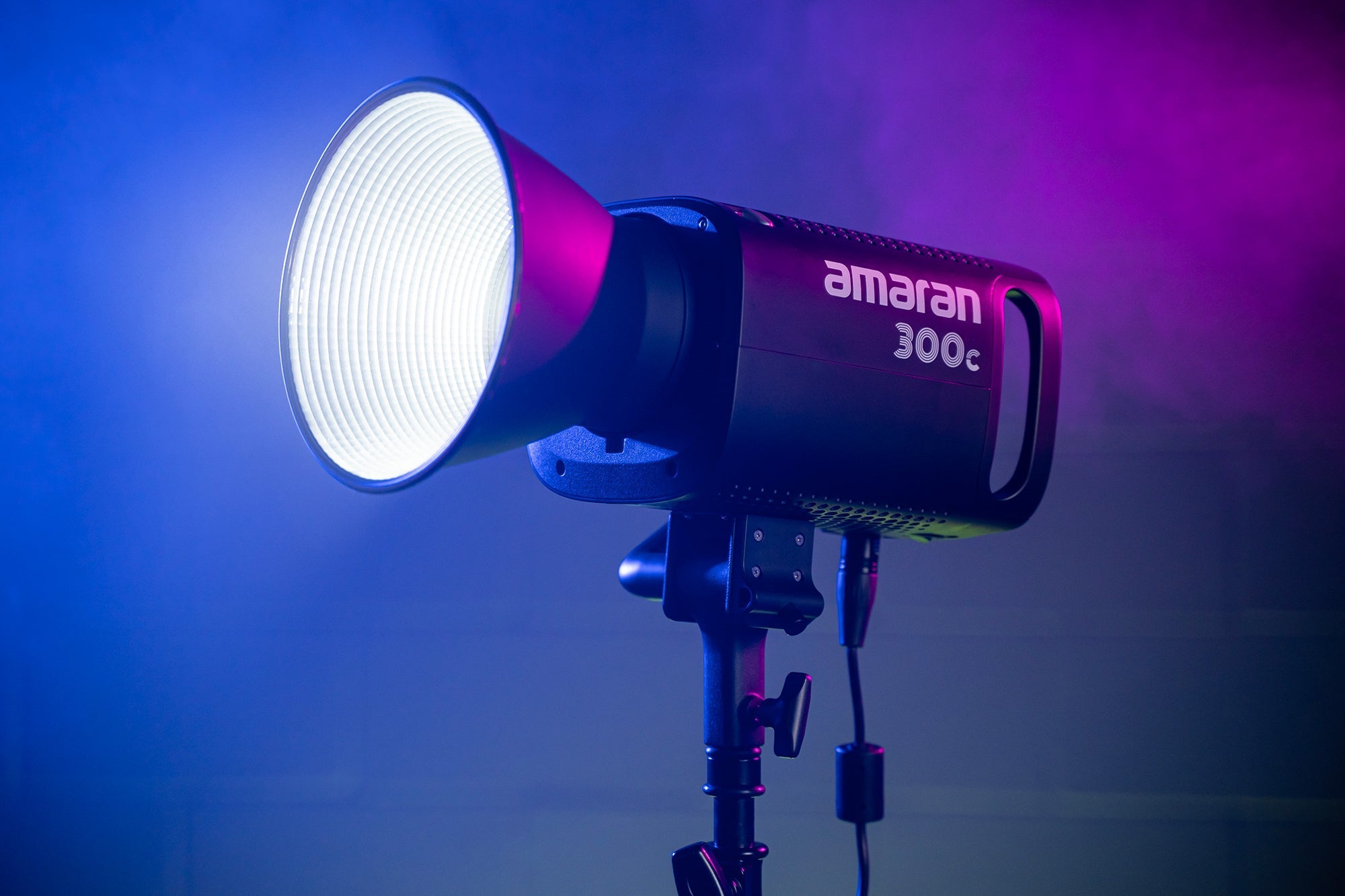 Amaran 300c LED CoB Light with Bowens Mount Hyper Reflector attached with vibrant lighting.